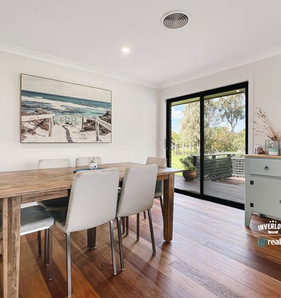 Bright dining area featuring large windows, showcasing views of the outdoors and modern design elements.