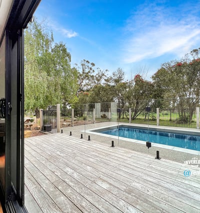 Spacious indoor-outdoor living with modern pool views, surrounded by lush greenery and serene landscapes.