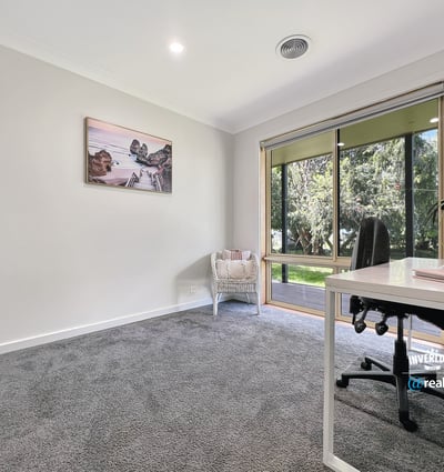 Bright and spacious room with large windows, offering peaceful views and ample natural light for productivity.