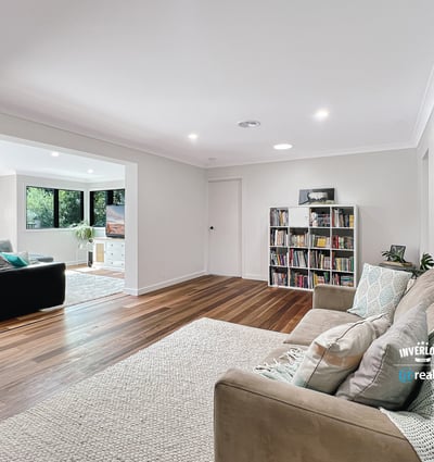 Spacious living area with modern finishes, large windows, and an inviting atmosphere perfect for relaxation.