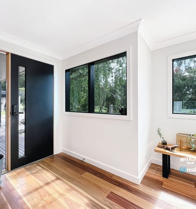 Bright entryway featuring large windows and natural light, welcoming you into a spacious home.
