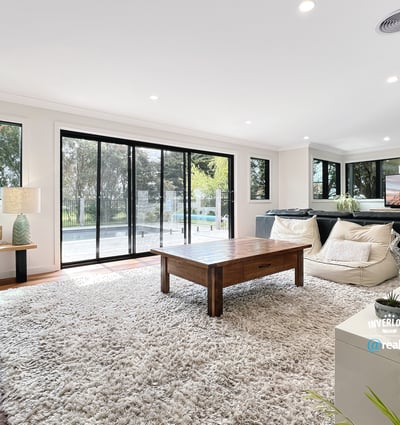 Spacious living area featuring large windows, modern furnishings, and seamless indoor-outdoor flow for relaxation and entertainment.