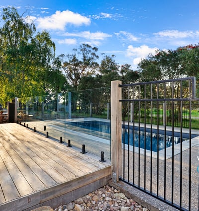 Discover a modern outdoor retreat featuring a pristine pool and expansive nature views, perfect for relaxation.