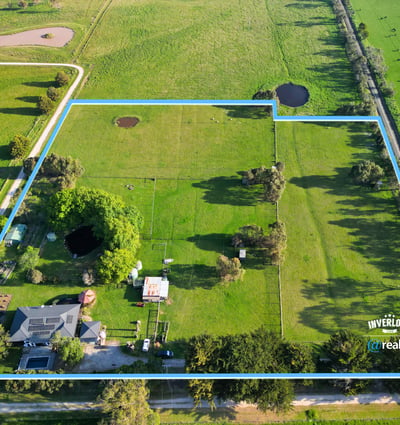 Expansive property featuring lush pastures and water features, perfect for agricultural pursuits or private retreat.