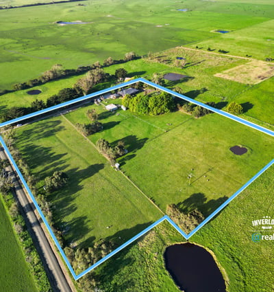 Spacious rural property featuring open fields, ponds, and mature trees, offering endless possibilities for development.