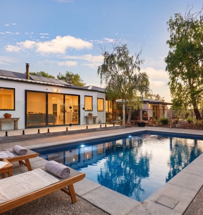 This modern home features a private pool and spacious outdoor area, perfect for entertaining and relaxation.