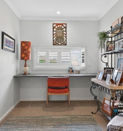Bright and airy workspace featuring a modern desk, natural light, and personalized decor for inspiration.