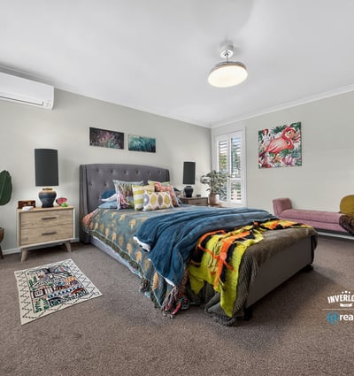 Spacious bedroom featuring modern décor, ample natural light, and cozy accents for a welcoming atmosphere.