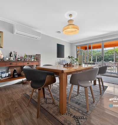 Bright and inviting dining area seamlessly connects to a lush outdoor space, perfect for entertaining.