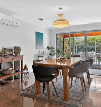Bright dining area featuring modern decor, large windows, and seamless outdoor access for entertaining.