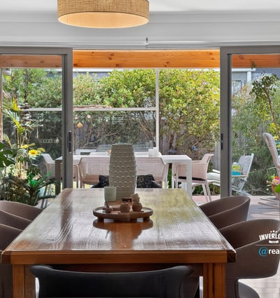 Bright dining area seamlessly connects to a spacious outdoor patio, perfect for entertaining and relaxing.