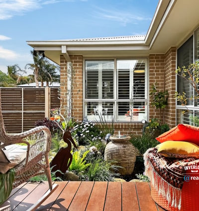 Discover a cozy outdoor space featuring lush landscaping, perfect for relaxation and outdoor gatherings.