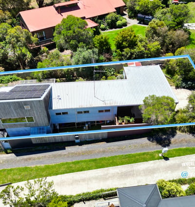 Modern home featuring spacious outdoor areas, situated on a beautifully landscaped lot with ample privacy.