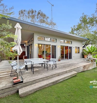 Bright, open-concept home featuring expansive outdoor living space and lush landscaping, ideal for entertaining.