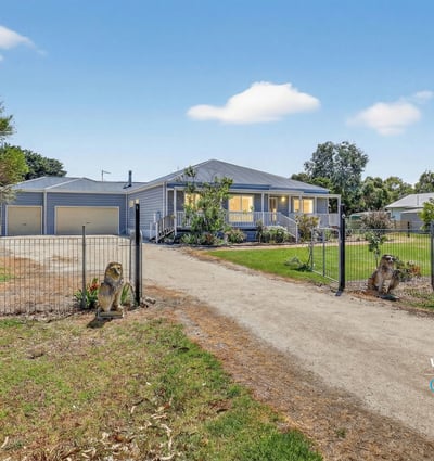 Spacious property with a welcoming entrance, featuring ample parking and beautifully landscaped grounds.