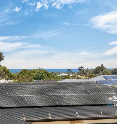 Modern home with solar panels and stunning ocean views, offering energy efficiency and coastal living.