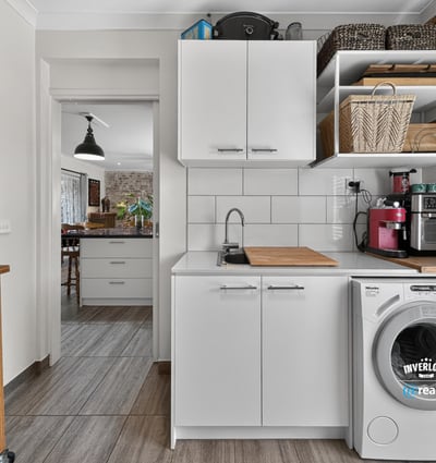 Bright and functional laundry area featuring modern appliances and ample storage for convenience and organization.