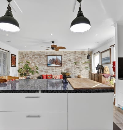 Inviting open-concept kitchen and living area featuring modern finishes and a cozy atmosphere for gatherings.