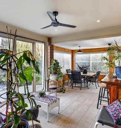 Bright and spacious sunroom featuring ample natural light, perfect for relaxing and entertaining.