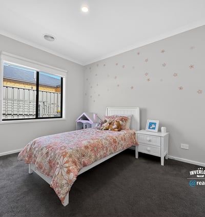 Bright and welcoming bedroom featuring modern decor and ample natural light, perfect for relaxation and rest.
