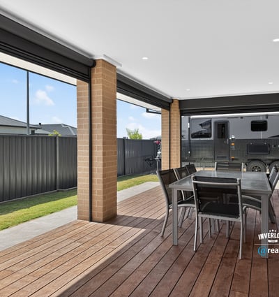 Spacious covered patio perfect for outdoor dining, featuring ample room for entertaining and relaxation.