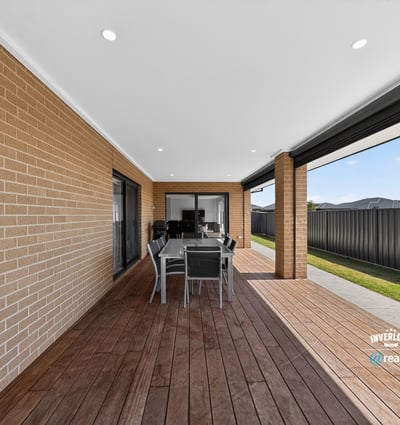 Spacious outdoor patio area perfect for entertaining, featuring a modern design and low-maintenance landscaping.