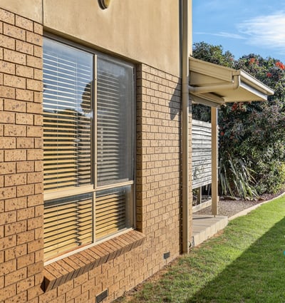 Spacious outdoor area with well-maintained landscaping and ample natural light streaming through large windows.