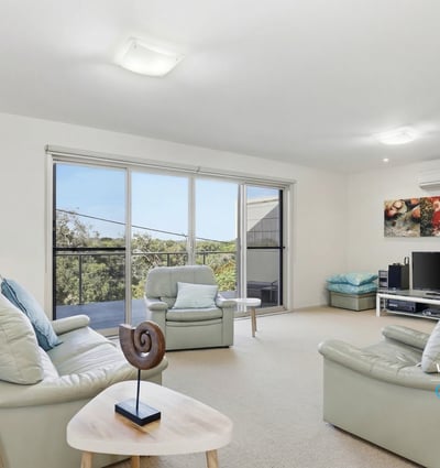 Bright and inviting living space featuring large windows and a seamless connection to the outdoor views.