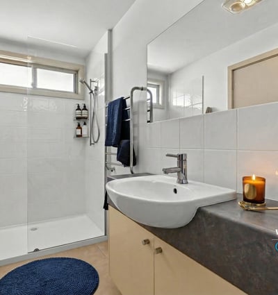 Modern bathroom featuring a spacious shower, sleek fixtures, and ample natural light, perfect for relaxation.