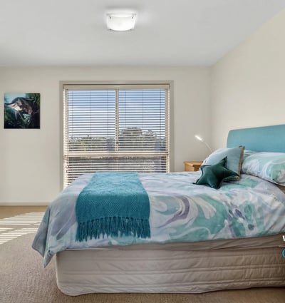 Bright and inviting bedroom featuring natural light, comfortable furnishings, and a peaceful atmosphere.