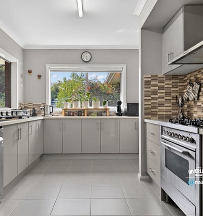 Bright and functional kitchen featuring modern appliances and a scenic view through large windows.