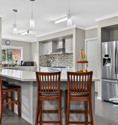 Modern kitchen featuring sleek appliances, ample counter space, and a breakfast bar perfect for gatherings.