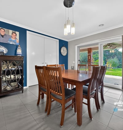 Spacious dining area with direct access to a well-maintained backyard, perfect for gatherings and entertaining.
