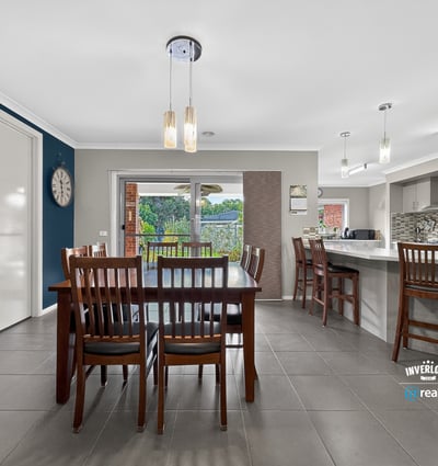 Modern kitchen and dining area with ample natural light and direct access to an outdoor space.