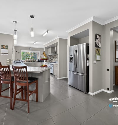 Modern kitchen with an open layout, featuring ample seating and contemporary appliances for everyday convenience.