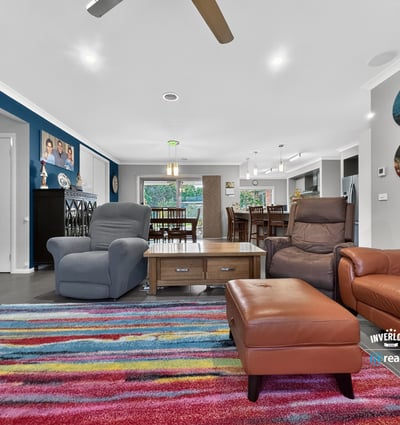 Spacious living area featuring vibrant decor, comfortable seating, and an inviting atmosphere for gatherings.