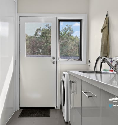 Bright and functional laundry area with modern appliances and natural light, perfect for everyday tasks.