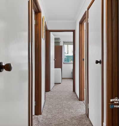 Discover a well-maintained hallway featuring ample natural light and easy access to various rooms.