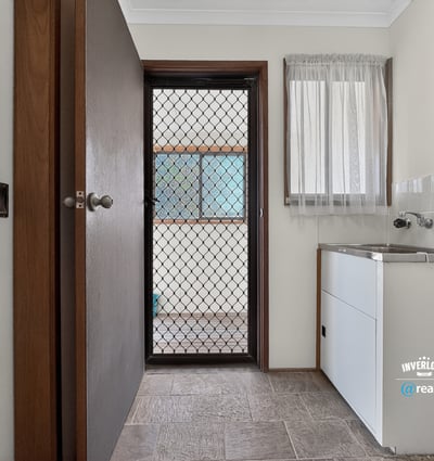 Spacious laundry area with practical features and bright natural light from nearby window.