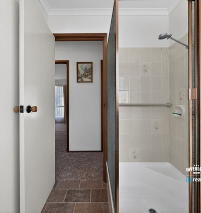 This bathroom features a convenient layout with practical finishes just steps from the living area.