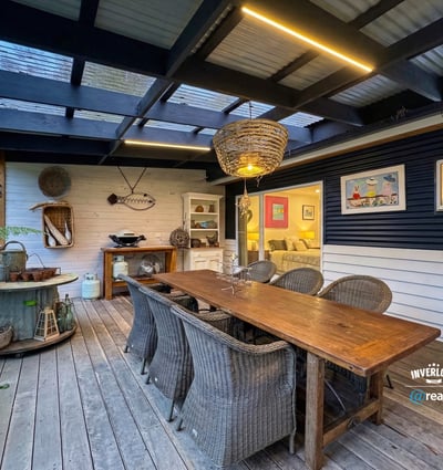 Spacious outdoor dining area with unique decor, perfect for gatherings and enjoying alfresco meals year-round.