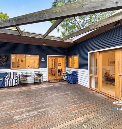 Spacious outdoor deck seamlessly connects to a cozy interior, perfect for entertaining and relaxation.