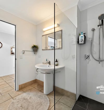 Modern bathroom featuring a spacious shower, contemporary fixtures, and a neutral color palette for a fresh feel.
