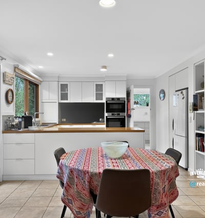 Bright, open kitchen with modern appliances and a spacious dining area, perfect for gatherings.