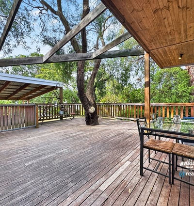 Spacious outdoor deck surrounded by nature, perfect for entertaining or relaxing in a private setting.