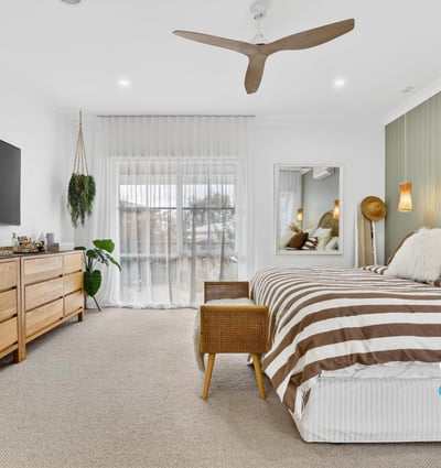 Bright and spacious bedroom featuring natural wood accents, large windows, and modern amenities for comfort.