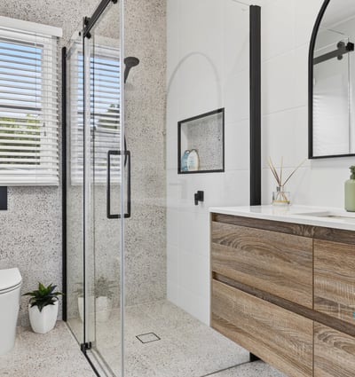 Modern bathroom featuring sleek lines, a spacious shower, and ample natural light for a refreshing ambiance.