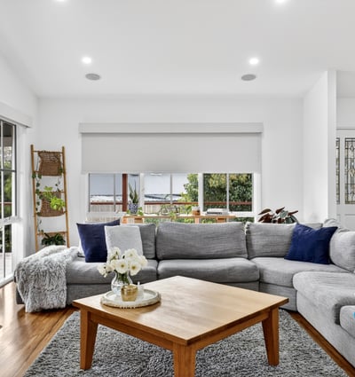 Spacious living area features large windows, offering abundant natural light and a cozy atmosphere.