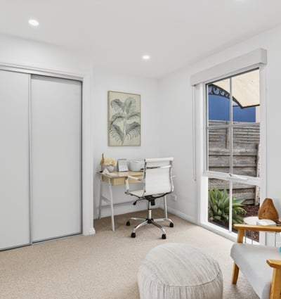 Bright and functional office space featuring natural light, modern furnishings, and streamlined storage solutions for productivity.