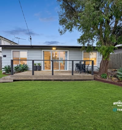 This inviting home features a spacious backyard and modern deck, perfect for outdoor gatherings and relaxation.